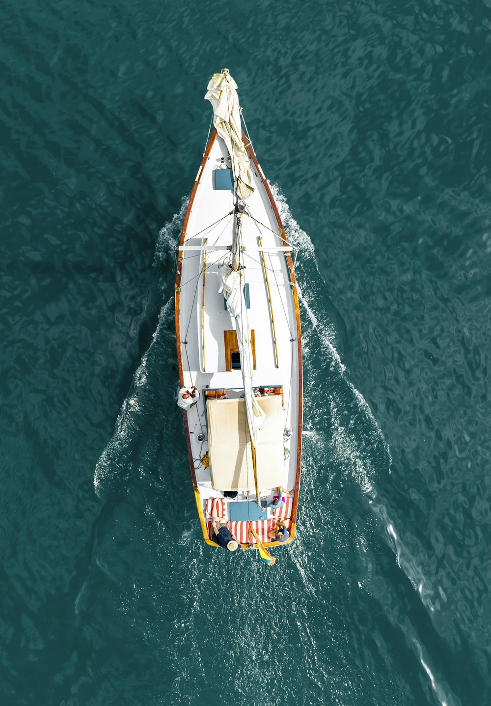 a small white boat floating on top of a body of water