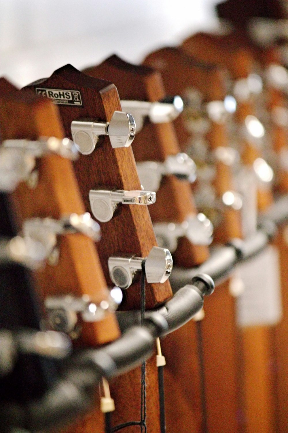 a row of wooden guitars are lined up