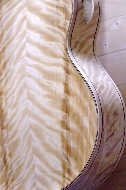 Artistic shot of a wooden guitar stand featuring natural grain patterns and warm tones.