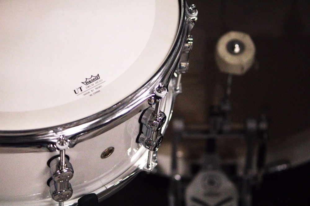 a close up of a white drum on a black background