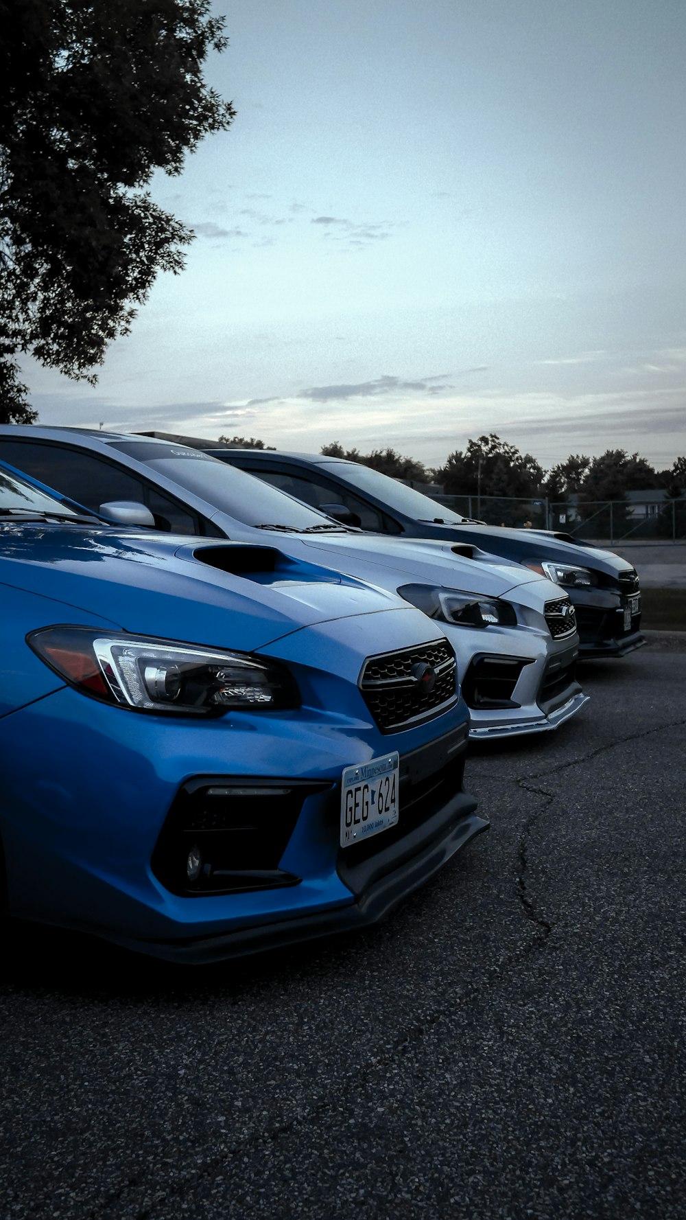 a row of cars parked in a parking lot