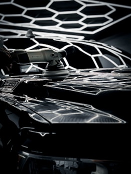 Professional-grade detailing tools like polishers and applicator pads arranged on a workbench.