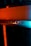 The image features the logo of Creality, likely on a 3D printer or similar device. The logo is set against a background with contrasting light, creating a dramatic effect. The lighting highlights the metallic texture of the logo, with a blend of warm orange and cool blue tones.