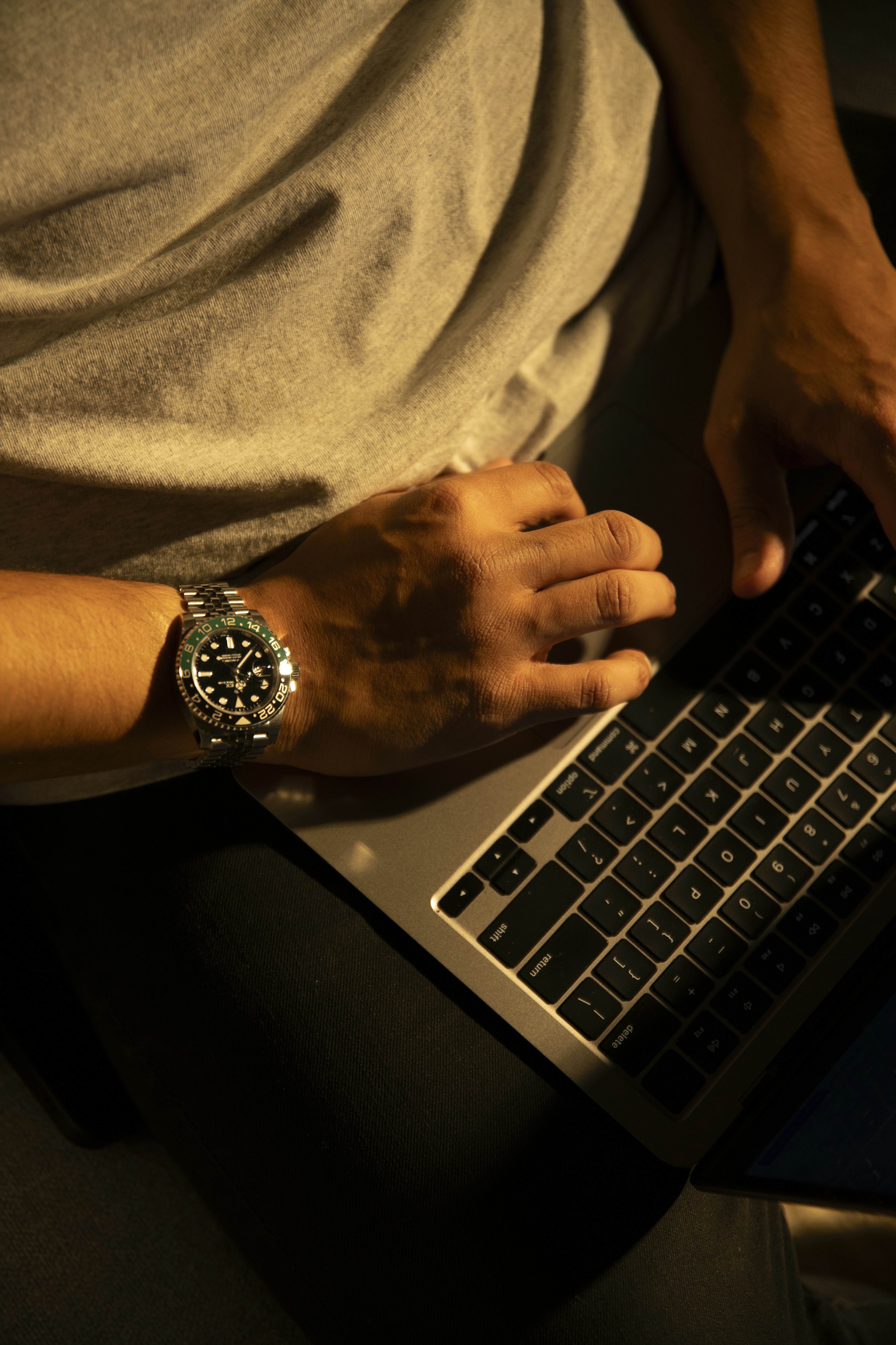a man sitting in front of a laptop computer
