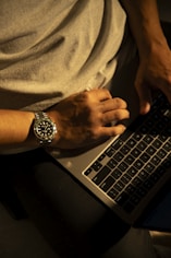 a man sitting in front of a laptop computer