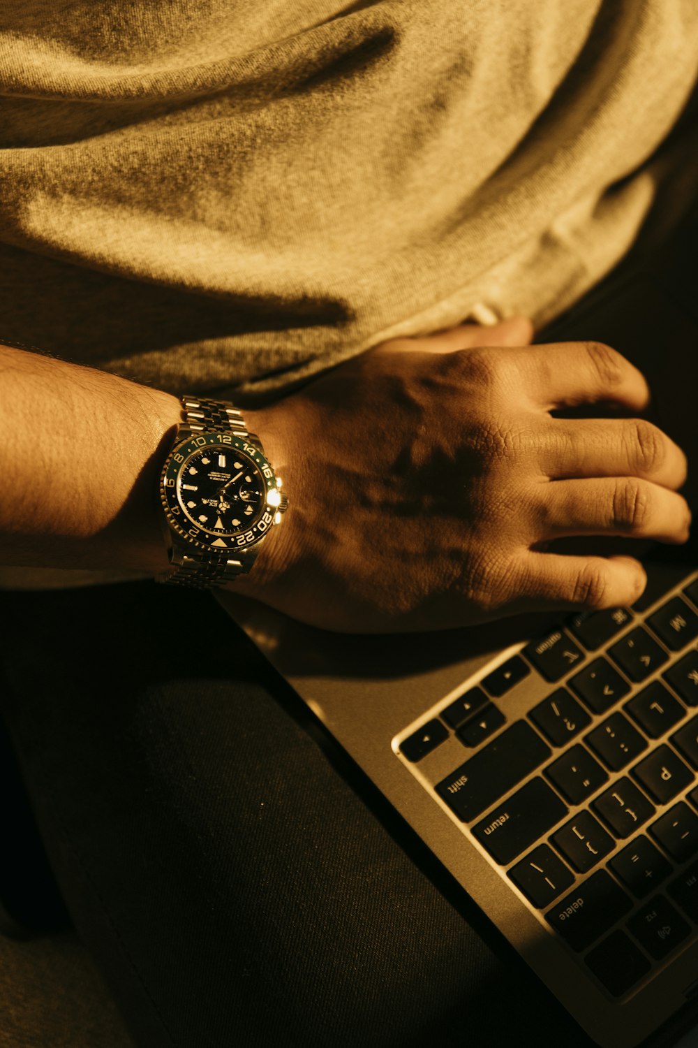 a person sitting in front of a laptop computer