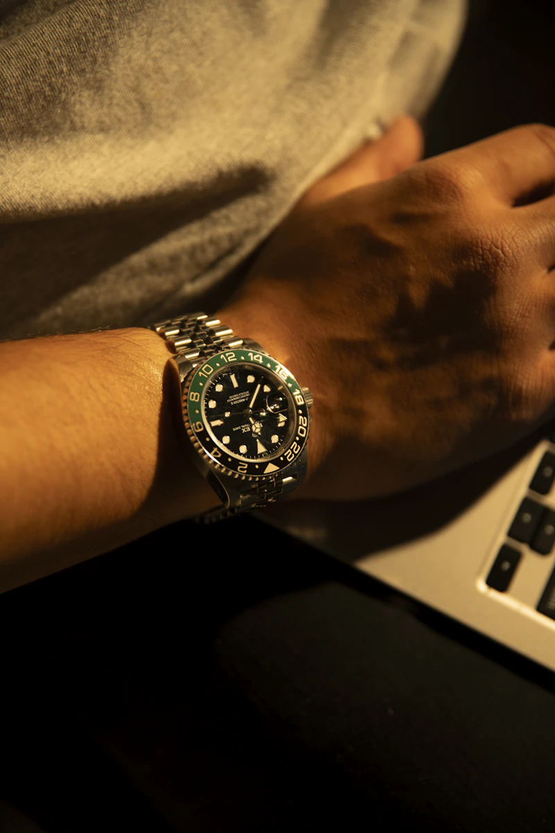 Close up of a person's wrist with a luxury Rolex watch