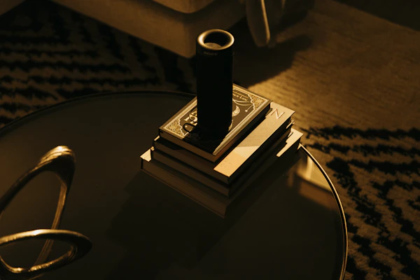 A cozy living room featuring a stylish smart speaker on a side table.