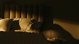 A cozy, softly lit bedroom corner with elegant sensual accessories displayed.