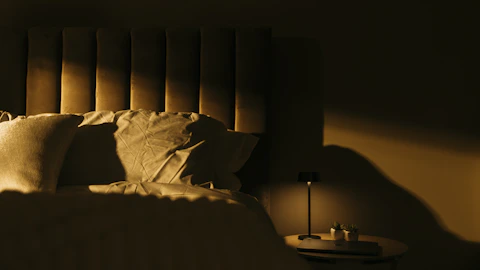 a bedroom with a bed and a night stand