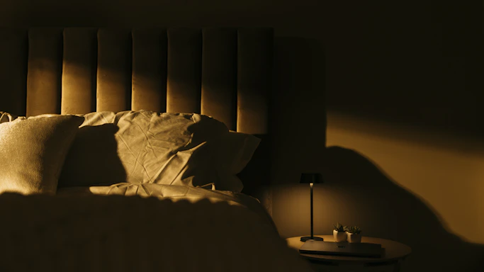 a bedroom with a bed and a night stand