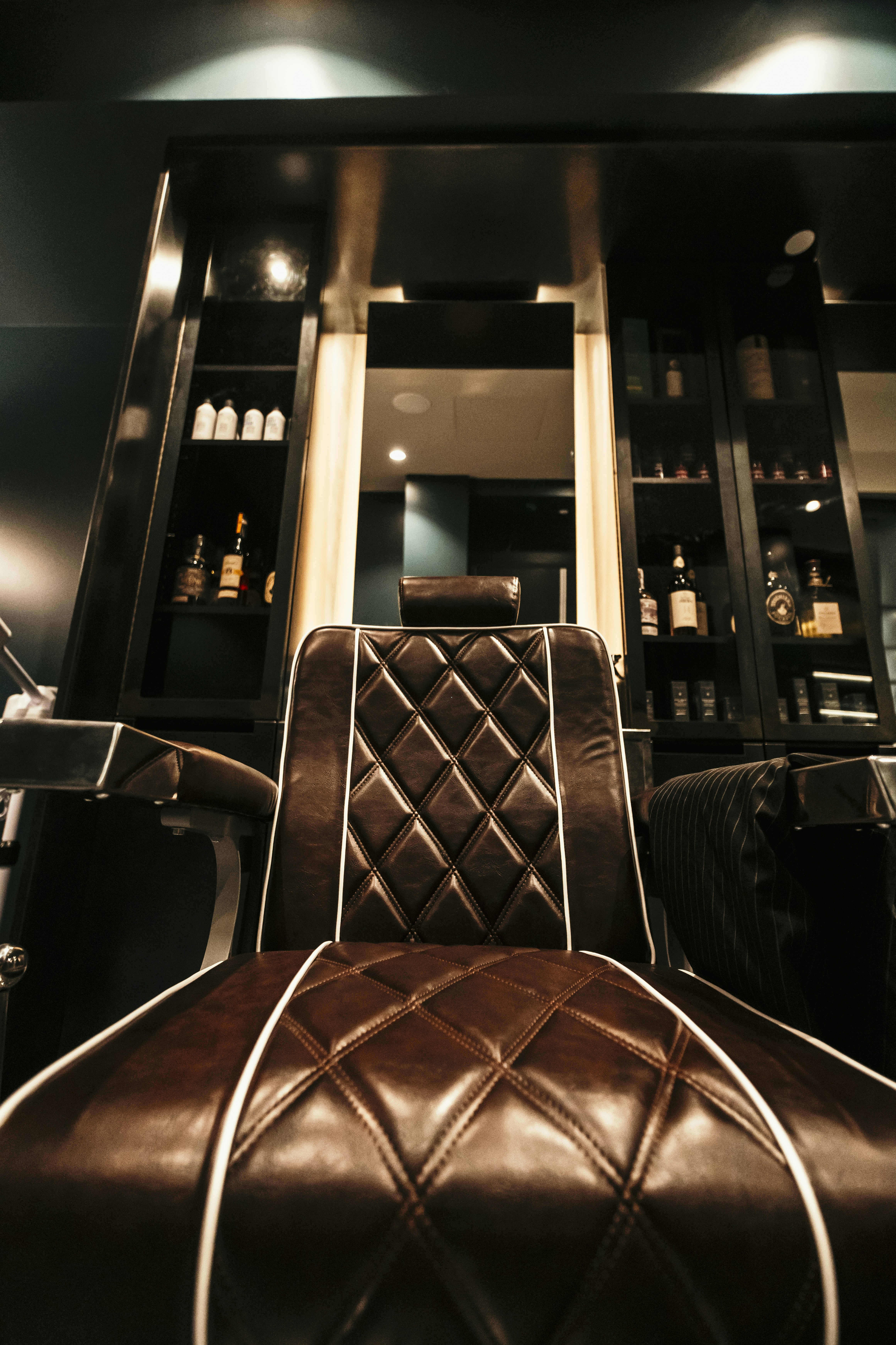 a brown leather chair sitting in front of a bar