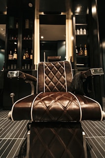 a brown leather chair sitting in front of a mirror
