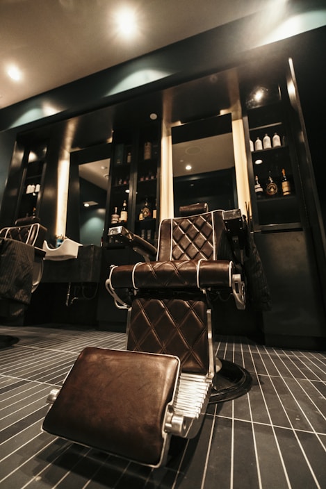 A stylish barber chair in a modern barbershop.