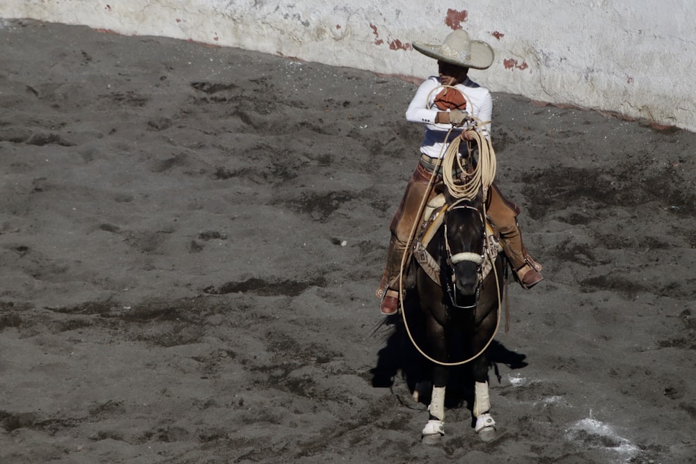 a man riding on the back of a brown horse