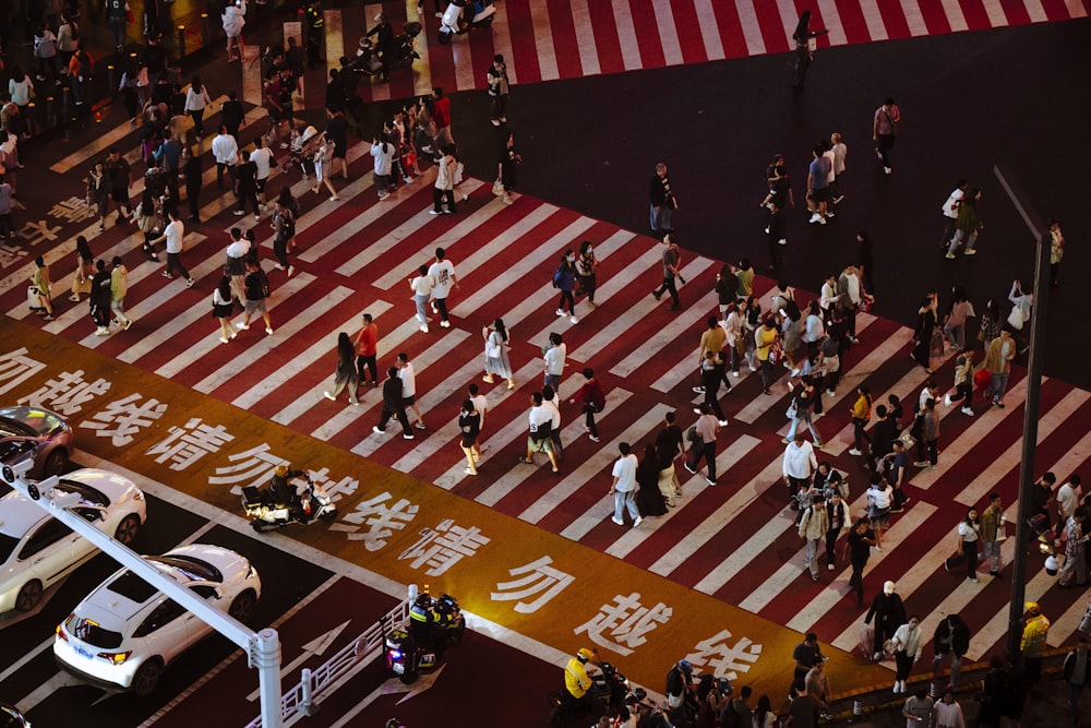 a large group of people walking across a street