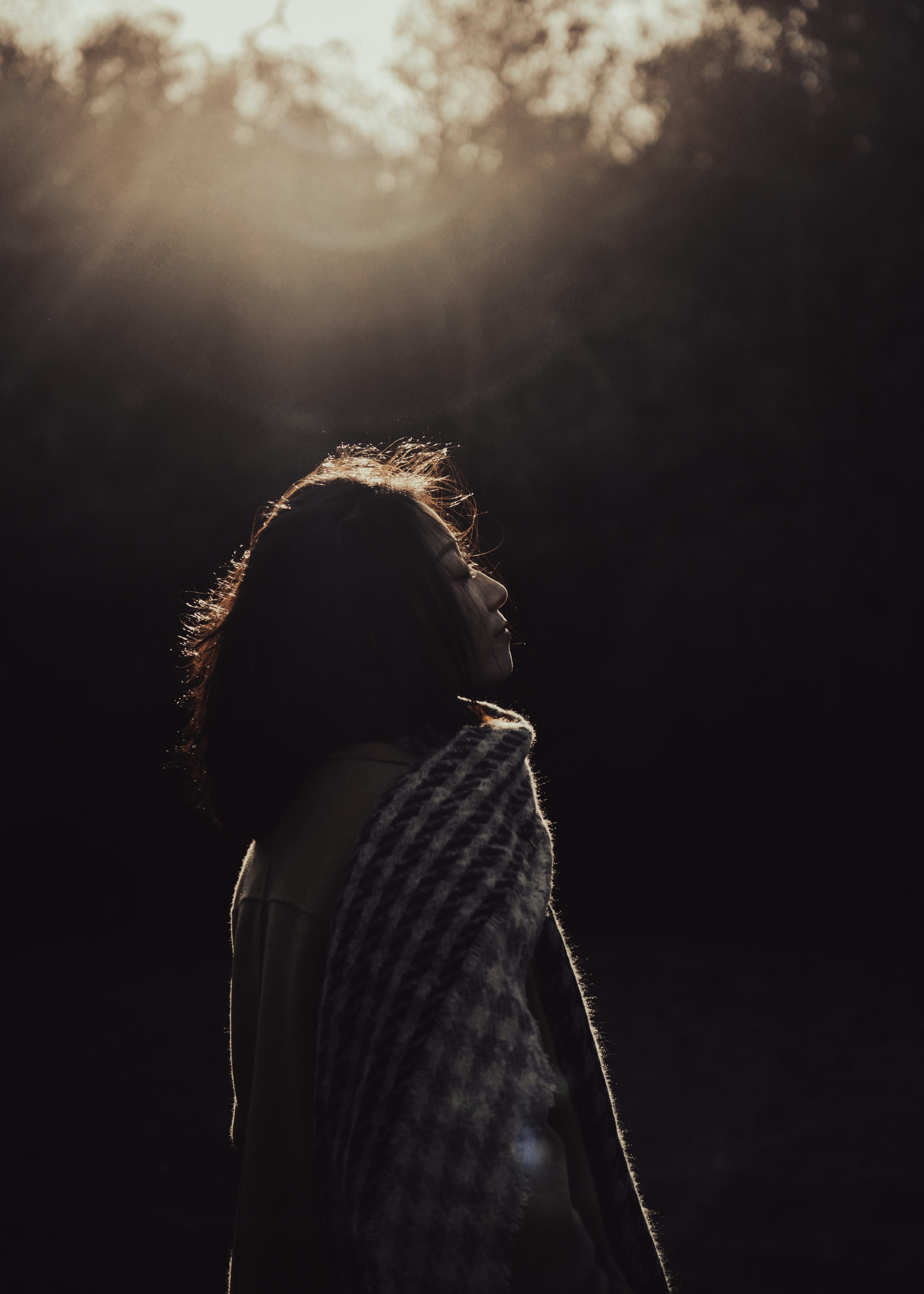 a woman standing in front of the sun