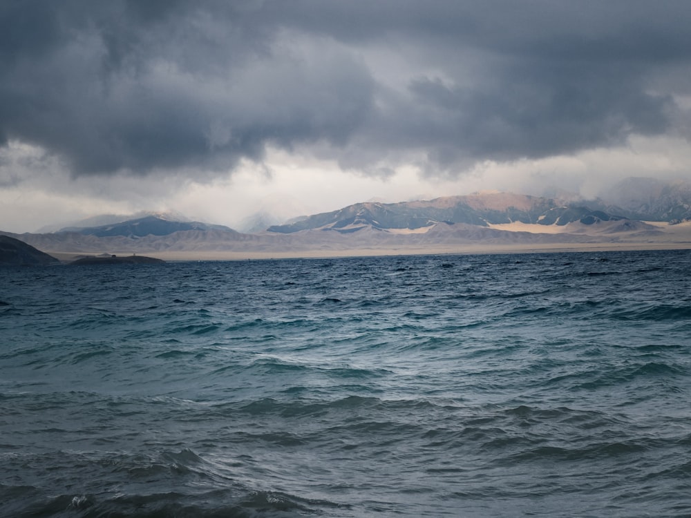 a large body of water under a cloudy sky