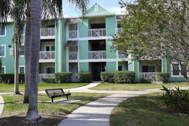 Exterior of a multifamily property managed by Reel Reef Properties, showing balconies and greenery