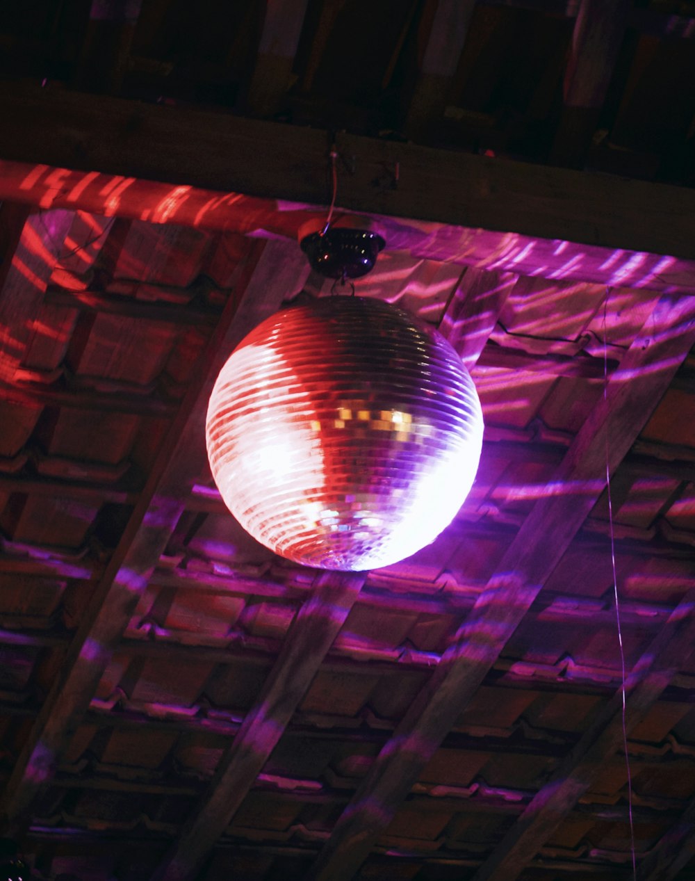 a disco ball hanging from the ceiling of a building