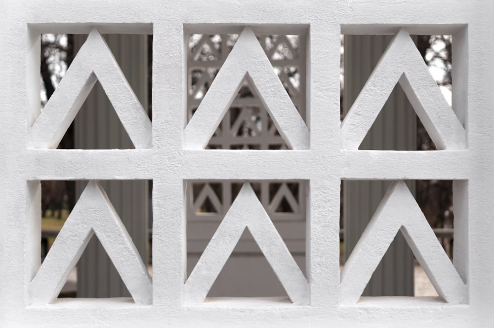 a close up of a white wall with a pattern on it