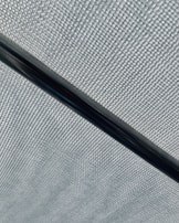 Hands inspecting a PTFE rod, highlighting the smooth texture and quality control.