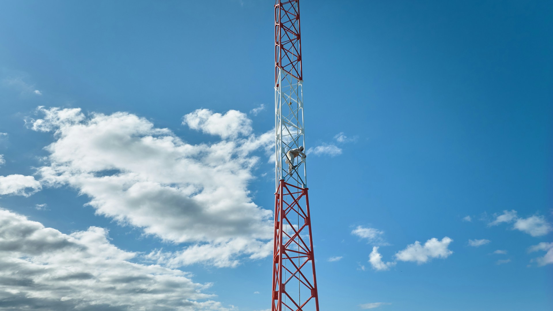 a red and white tower on a clear day