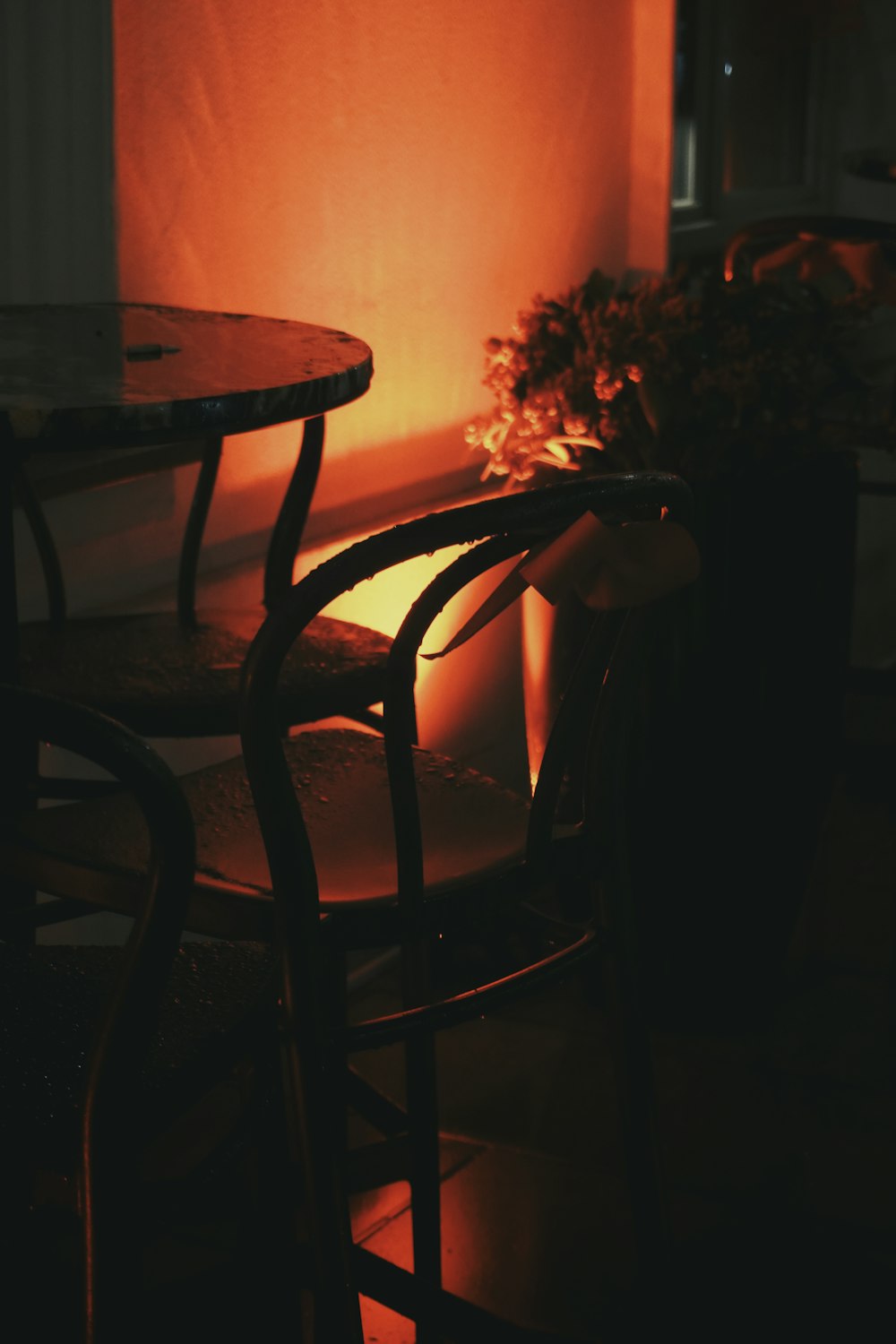 two chairs and a table in a dimly lit room