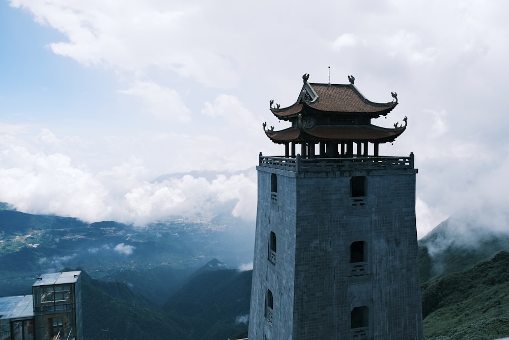 a tall tower sitting on top of a lush green hillside