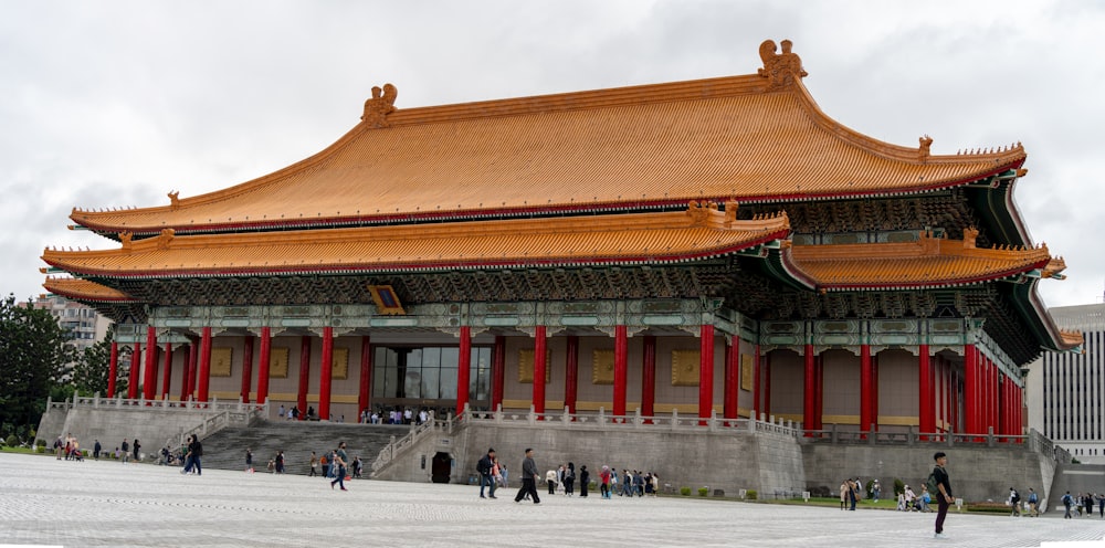a large building with a golden roof and red columns