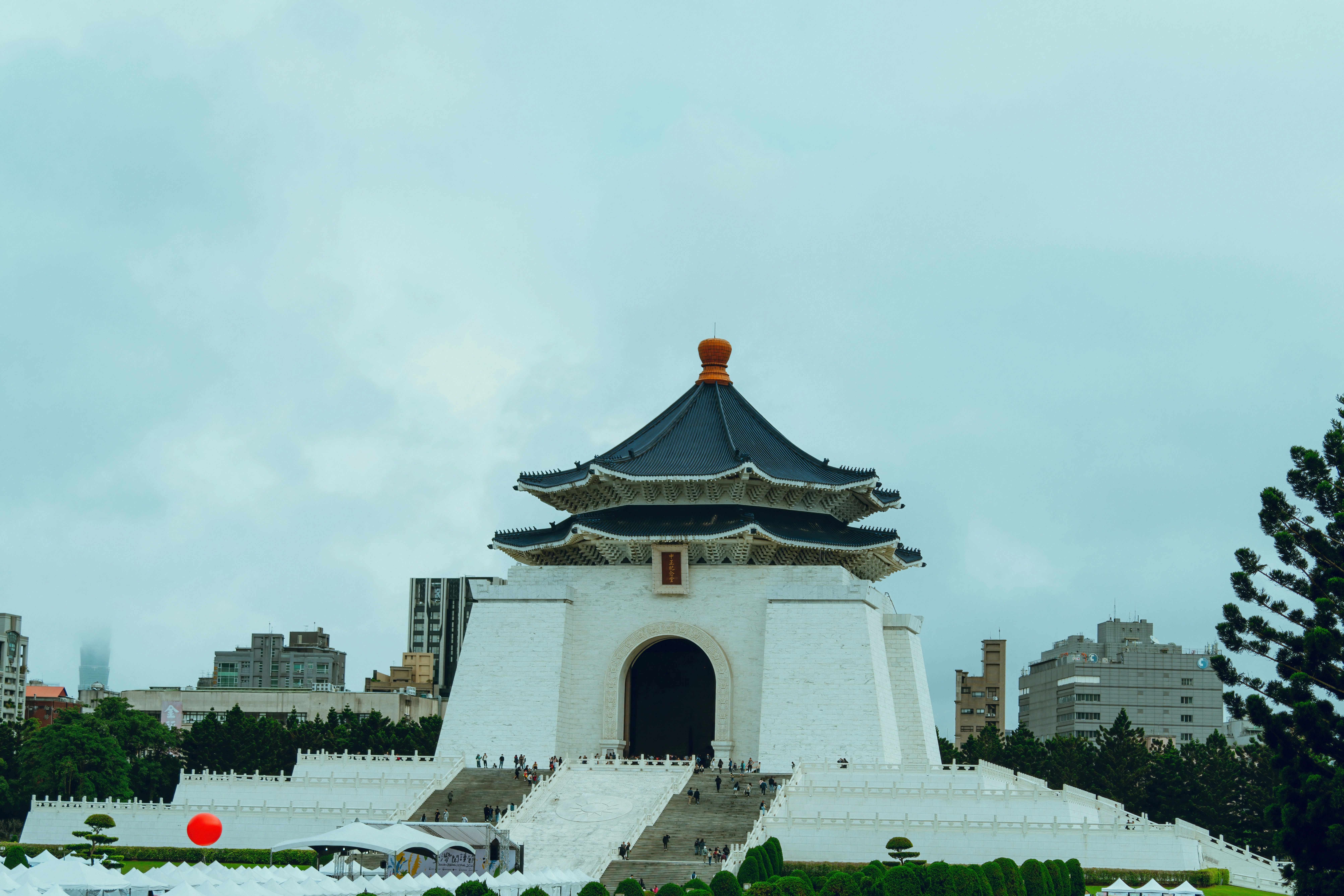 a tall white building with a black roof