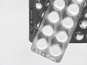 Packaging of transdermal patches with clear labels and modern design on a clean white table.