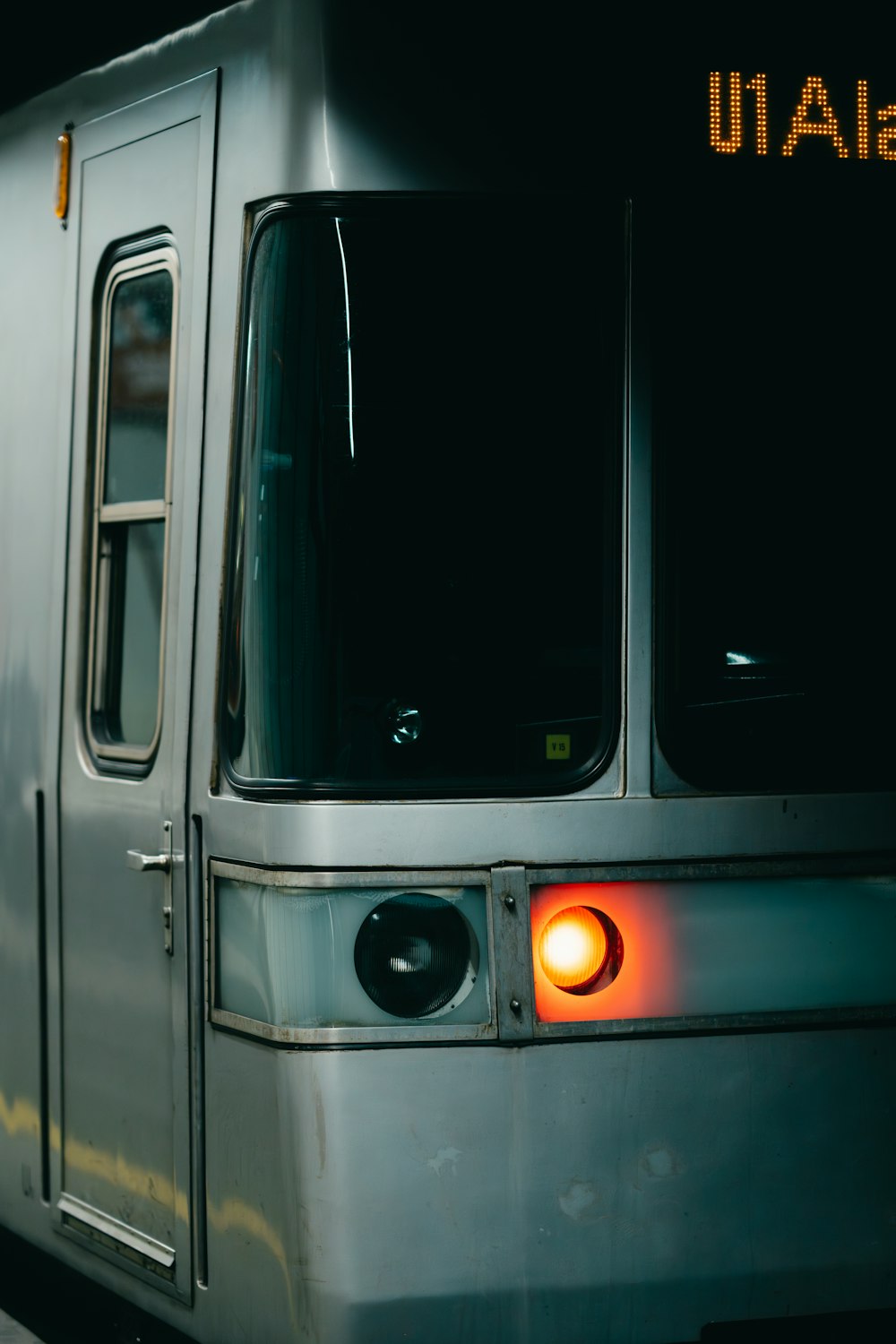 a subway train with its lights on at night