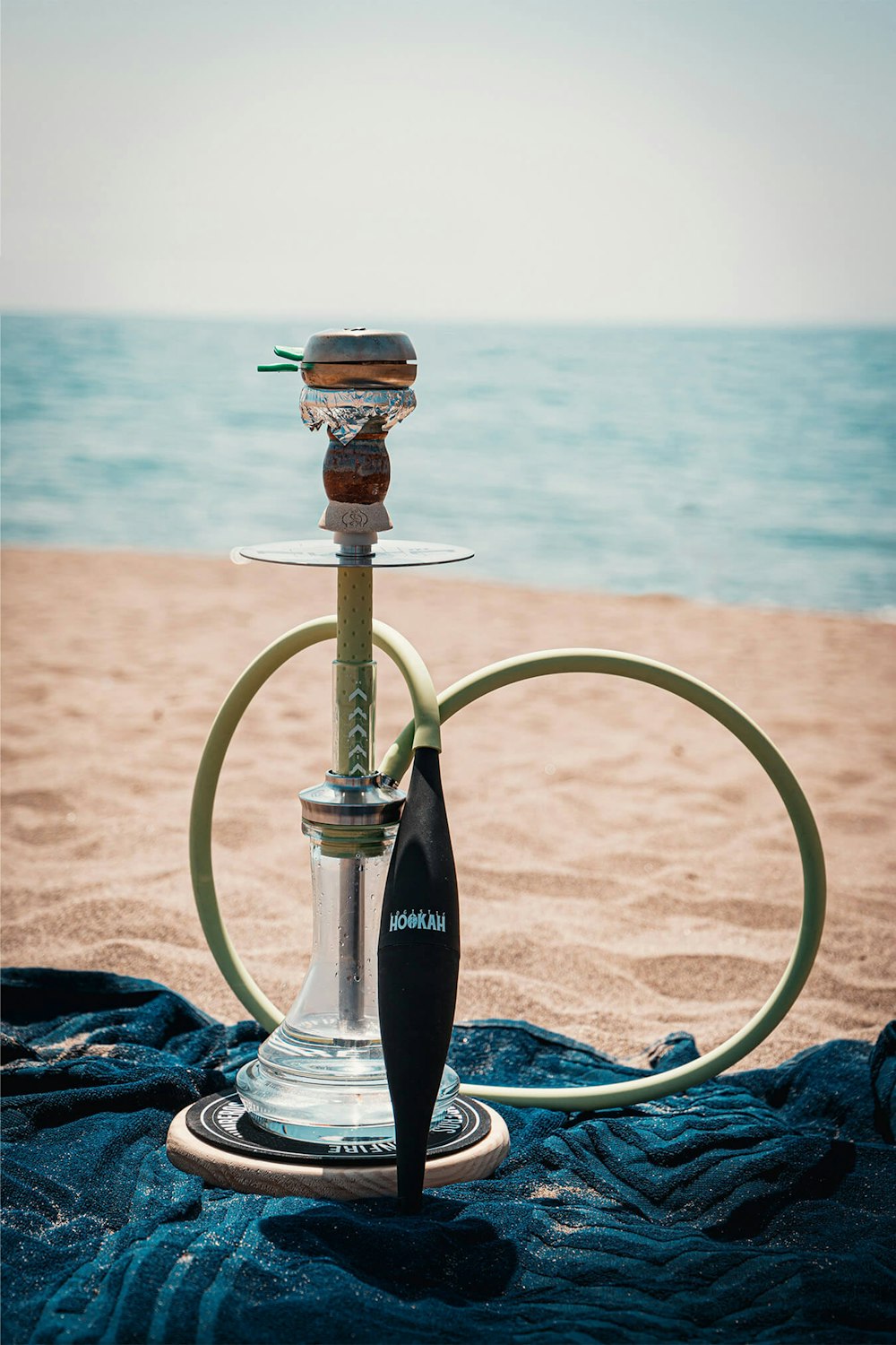 a hookah sitting on top of a table next to the ocean