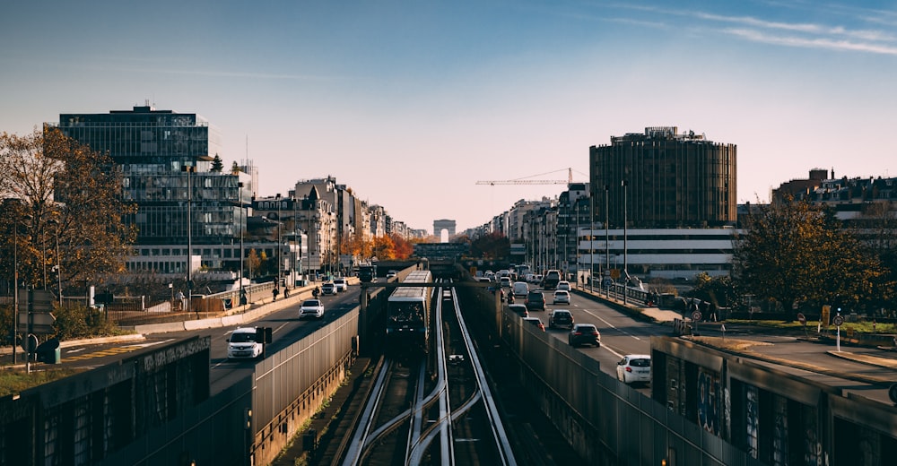 a train traveling down train tracks next to tall buildings