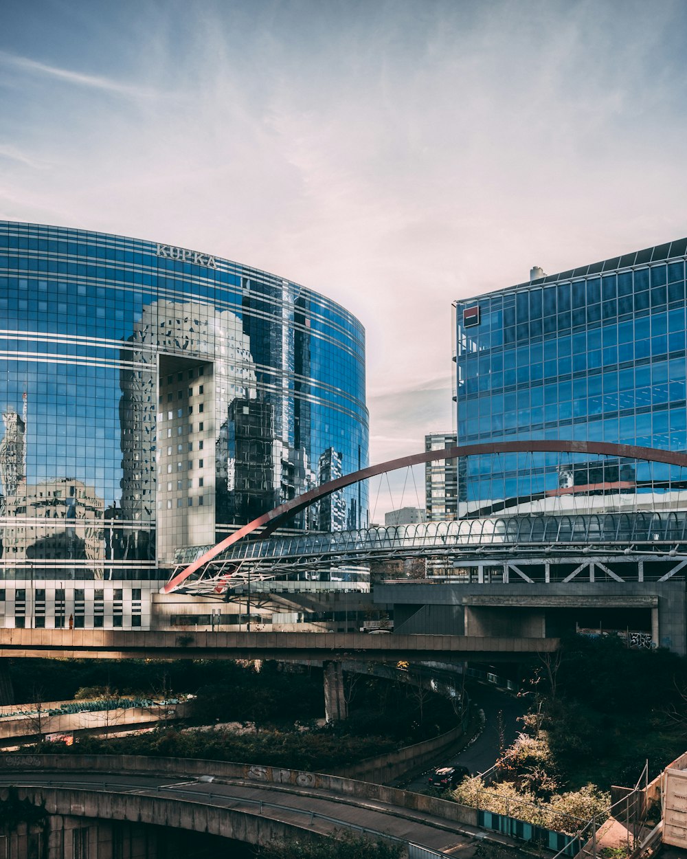 a bridge over a river in front of a large building