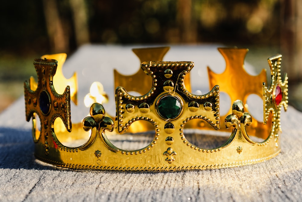 a gold crown sitting on top of a wooden table