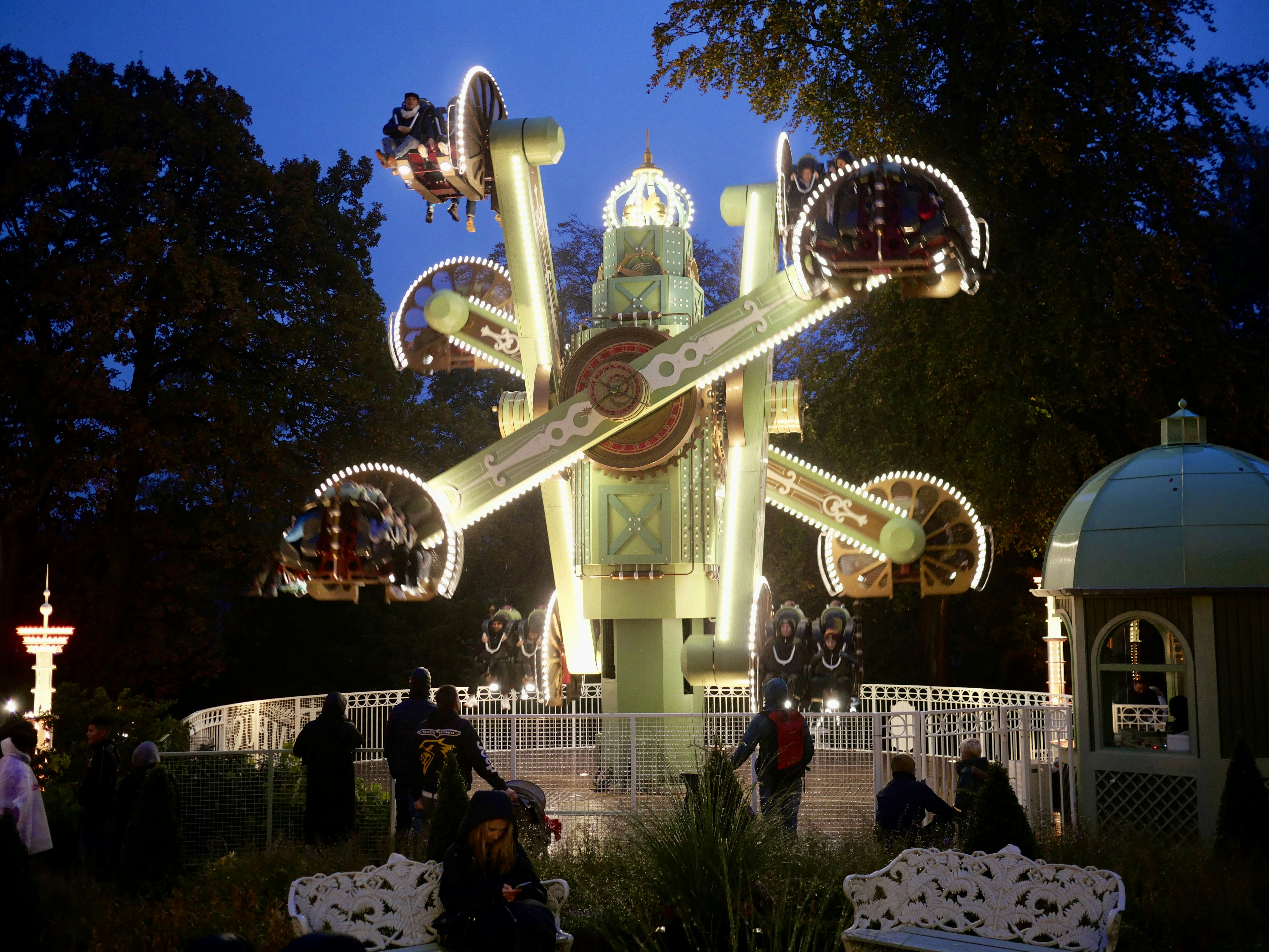 a carnival ride at night with people standing around