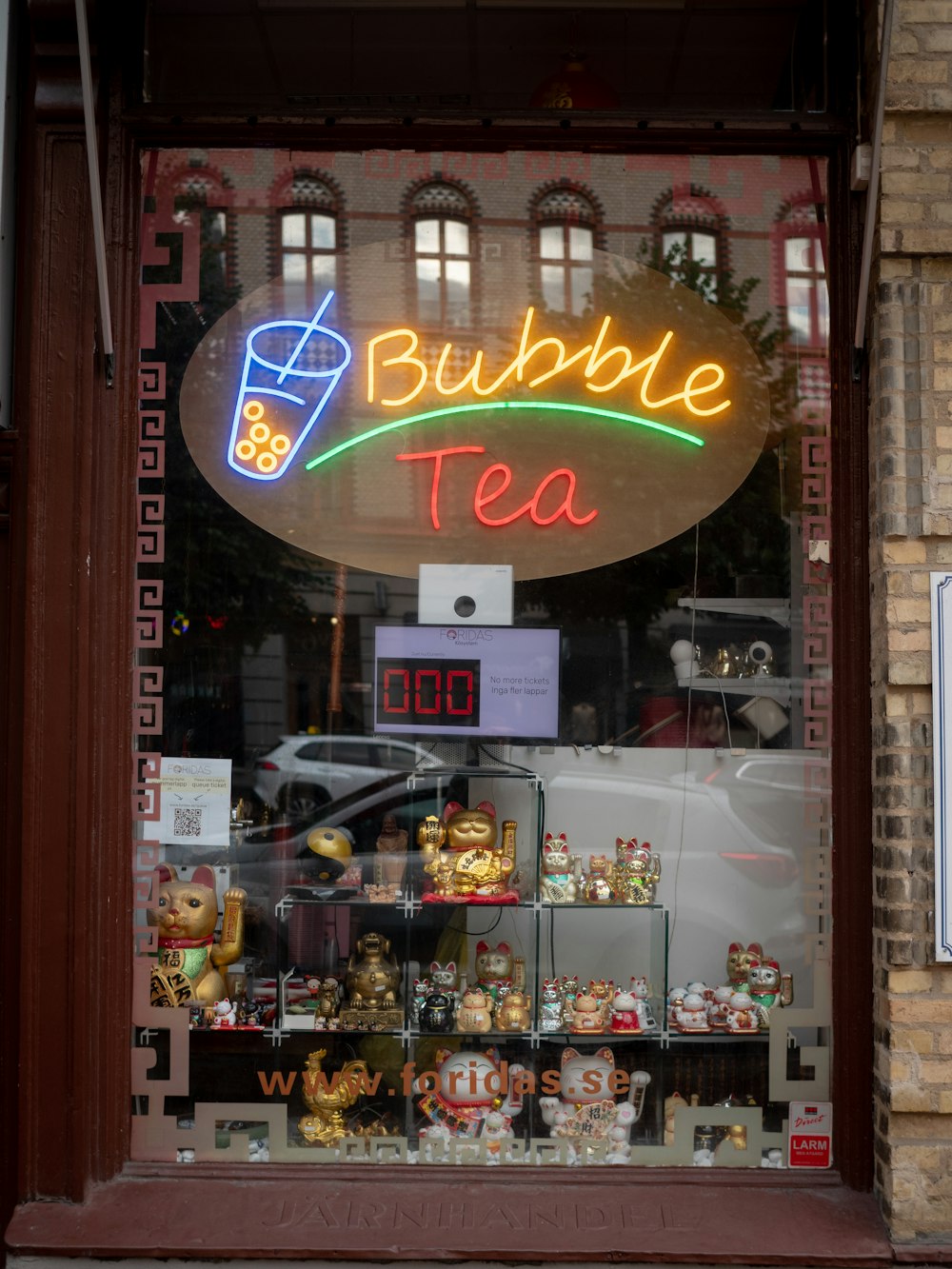 a store front with a neon sign that says bubble tea