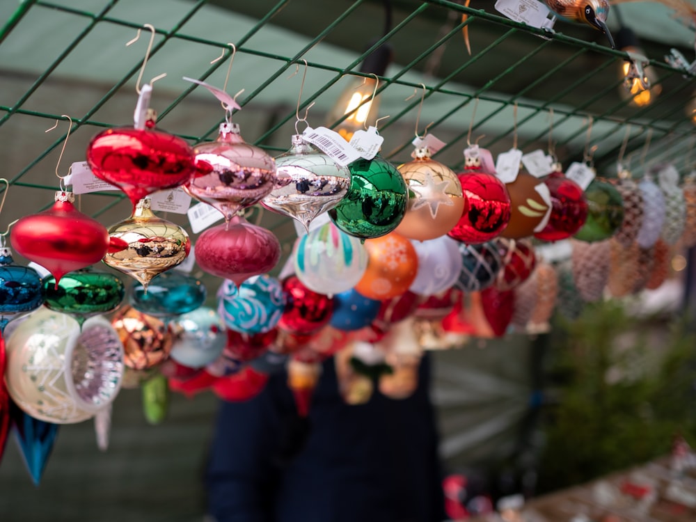 a man standing next to a display of christmas ornaments