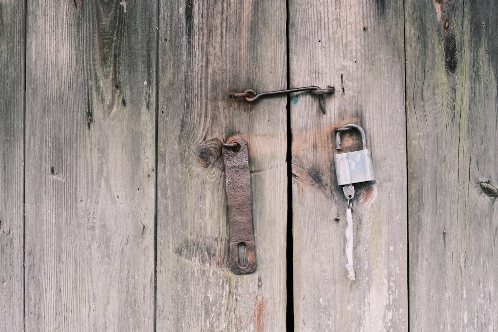 a padlock on the side of a wooden door