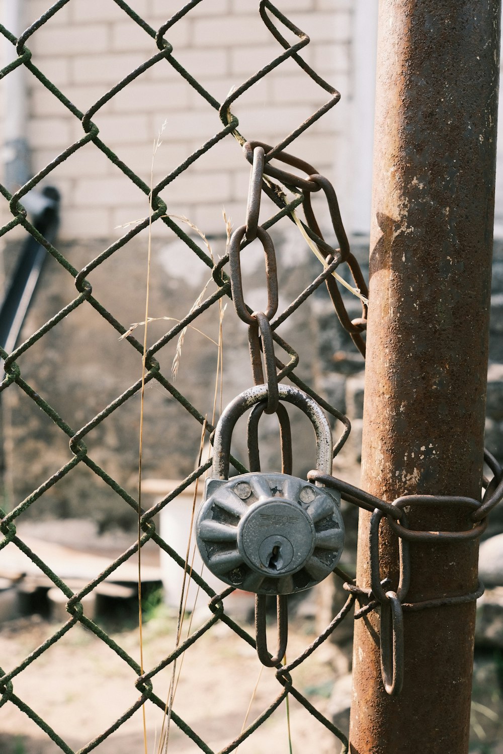 a chain link fence with a padlock attached to it