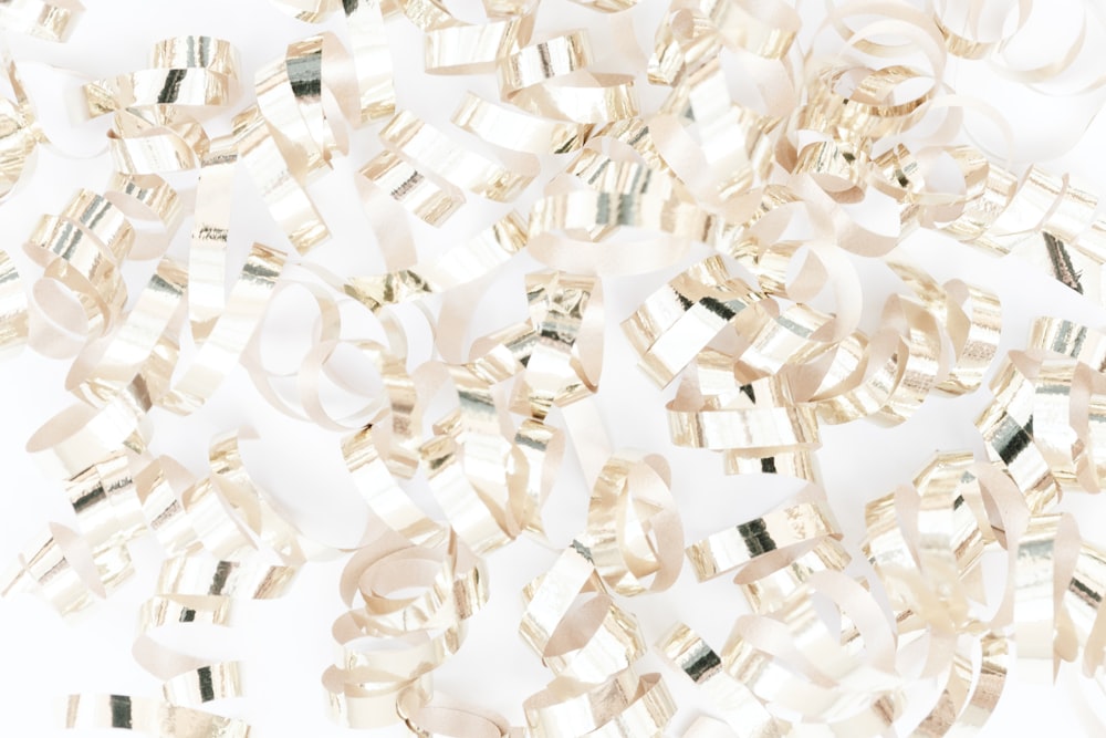 a pile of shiny ribbons on a white background