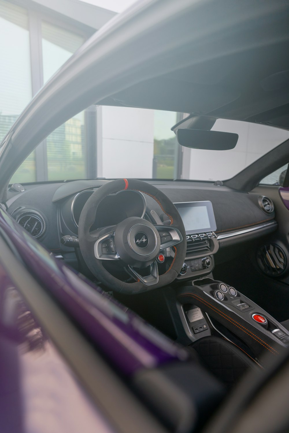 the interior of a car with a steering wheel and dashboard