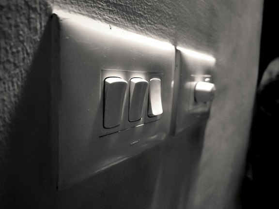 Variety of electric switches displayed on a wall.