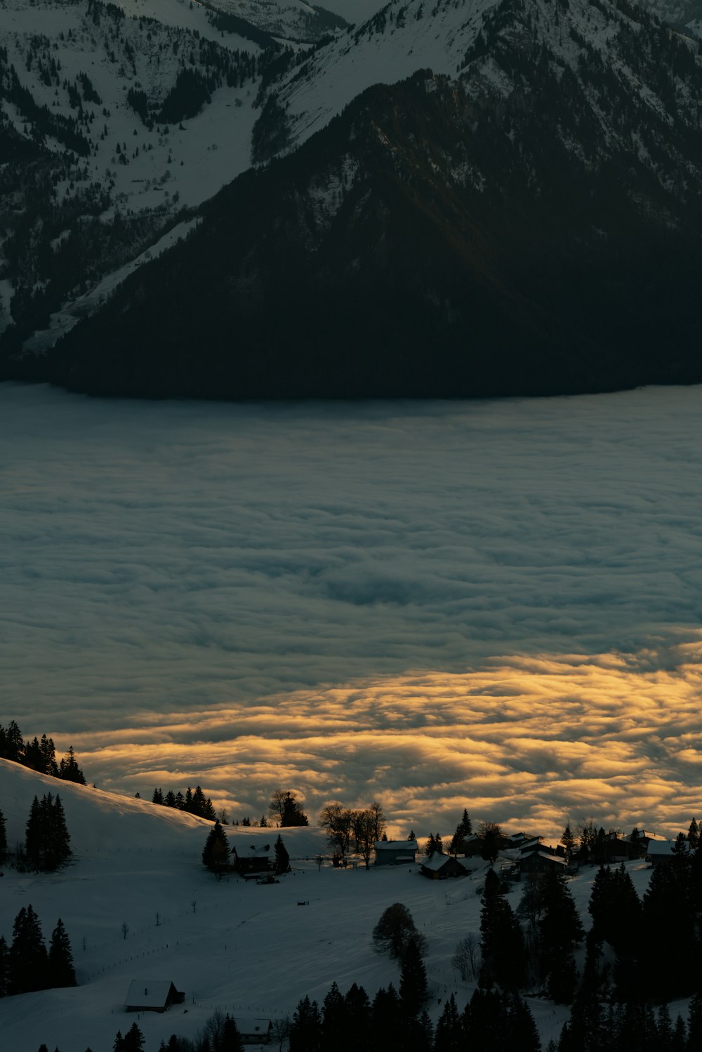 a view of a mountain range covered in clouds