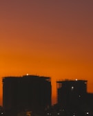 A stunning aerial view of a Sobha development under construction at sunset.