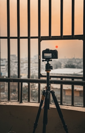 CCTV camera mounted on a residential building in Gorontalo during sunset