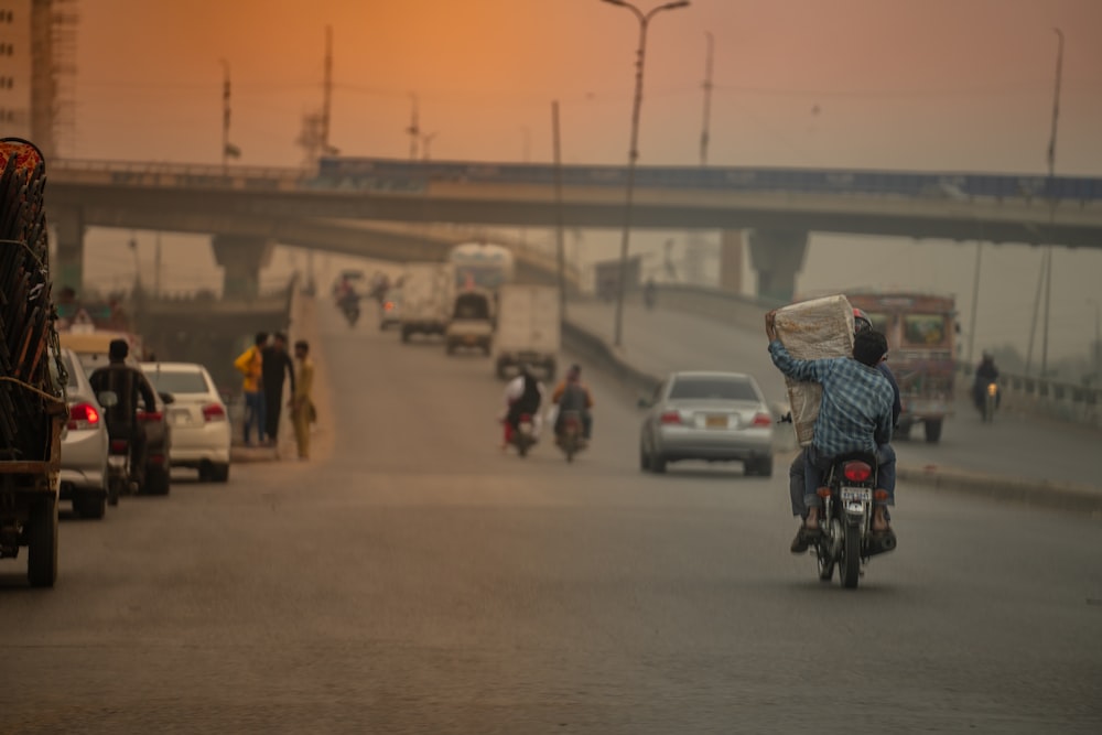 a man riding a motorcycle down a street