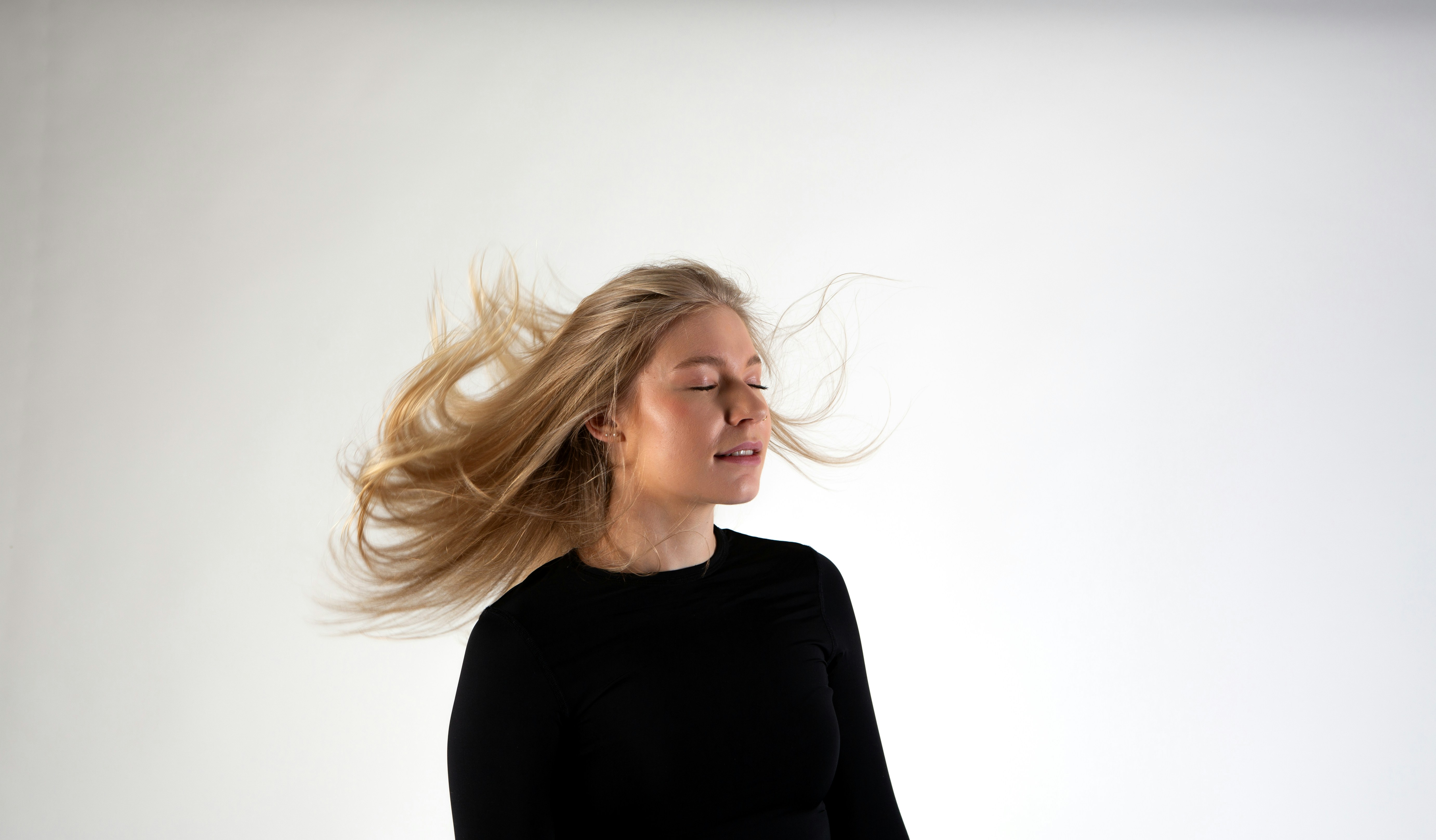 a woman with her hair blowing in the wind
